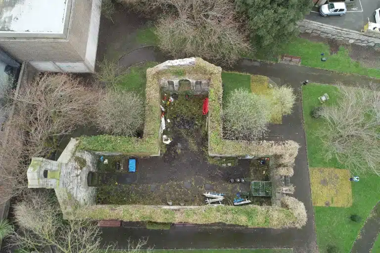 Vertical top-down drone photograph of historic abbey ruins in Ireland